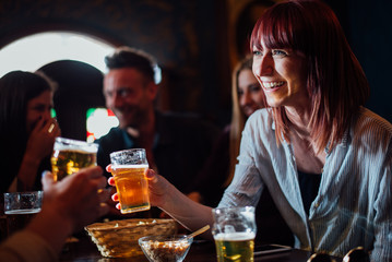 Group of teens having fun in a pub