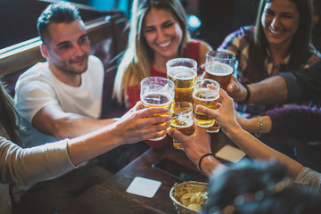 Group of teens having fun in a pub
