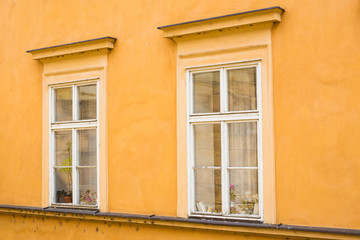 Fototapeta na wymiar European yellow colorful house wall and windows.