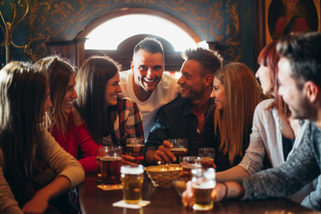 Group of teens having fun in a pub