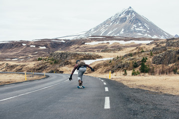 Skater traveling iceland on his longboard