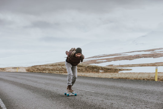 Skater traveling iceland on his longboard