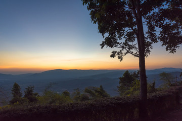Fototapeta na wymiar Scenic view of sunrise mountains at northeast Thailand, Mountain range for climbing in mountain trails. the landscape of mountain which including of copy-space for texting. 