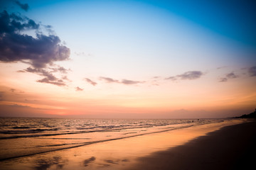 Obraz premium Nature in twilight period which including of sunrise over the sea and the nice beach. Summer beach with blue water and purple sky at the sunset.