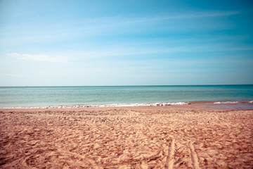 Nature in twilight period which including of sunrise over the sea and the nice beach. Summer beach with blue water and purple sky at the sunset.