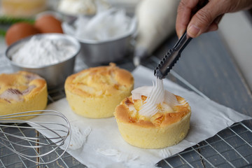 Cook preparing a sweet cake topping Coconut meat on it