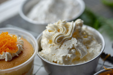 Cook preparing a sweet cake topping whipped cream and putting golden threads Thai Traditional Dessert on it