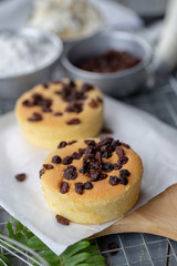 Cook preparing a sweet cake topping with raisin on it