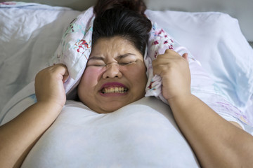 Frustrated overweight woman unable to sleep