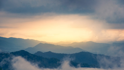 Scenic view of sunrise mountains at northeast Thailand, Mountain range for climbing in mountain trails. the landscape of mountain which including of copy-space for texting. - Vintage retro tone.