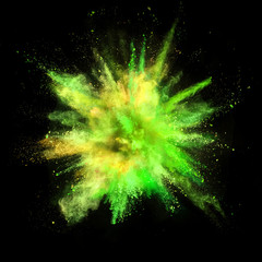 Explosion of coloured powder isolated on black background.