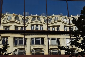 Reflections of a French building in distorted glass