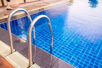 Swimming pool with stair at hotel. Foam board for the teaching of swimming beside swimming pool. - Vintage Tone.