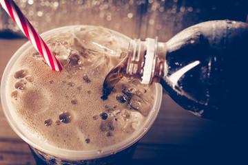 Refreshing Bubbly Soda Pop with Ice Cubes. Cold soda iced drink in a glasses - Selective focus,...