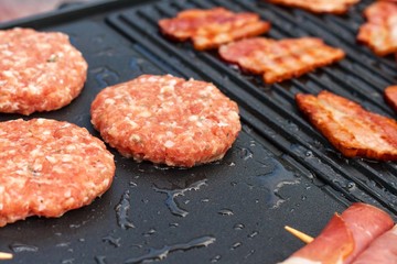 Meat on an electric grill. Home cooking. Healthy barbecue. Catering to friends. Electric grilling.