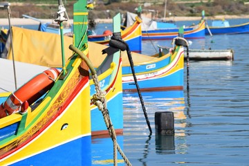 Fototapeta na wymiar Bow of fishing boats in in Marsaxlokk
