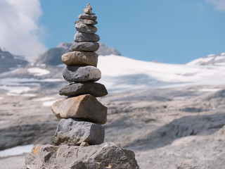 Fototapeta na wymiar close up from stacked, balanced rocks in front of a glacier in summer,beautiful balance