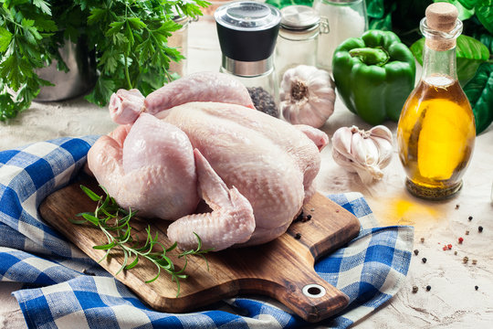 Whole Raw Chicken On Wooden Cutting Board