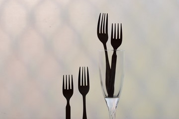 symbolic arrangement of fork representing love and family black and white silhouette