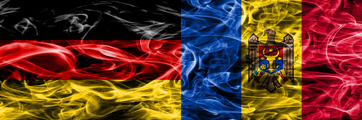 Germany vs Moldova smoke flags placed side by side. German and Moldova flag together