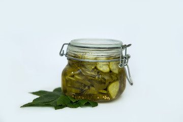Pickled cucumbers in a jar with black currant leaves