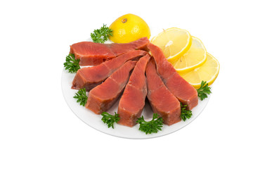 pink salmon salted fillets sliced with herbs and lemon on a plate isolated on white background