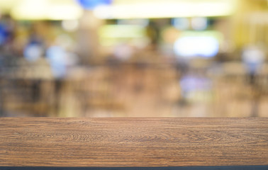 Empty dark wooden table in front of abstract blurred bokeh background of restaurant . can be used for display or montage your products.Mock up for space.