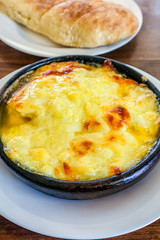 Fried suluguni cheese. Georgian national dish in a clay plate.