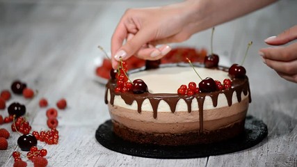 Triple chocolate mousse cake decorated with fresh berries. - Powered by Adobe