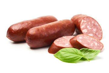Smoked sausages with sausage slices and basil herb, isolated on white background.