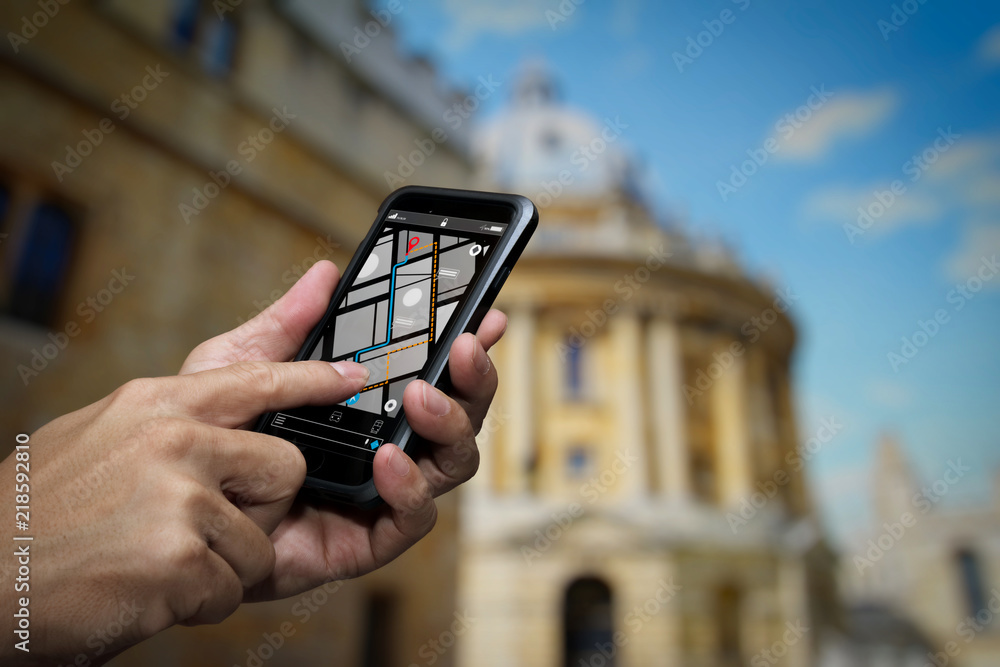 Poster Close up of Tourist using GPS map navigation on smartphone application screen for direction to destination address in the city with travel and technology concept.