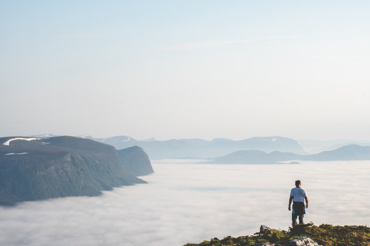 Guy Running On Top Of A Mountain.