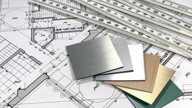 Blueprints: architectural drawings, yardstick - folding ruler & samples of modern interior decoration materials - decorative plastics smoothly rotate on the surface of the architectural plan