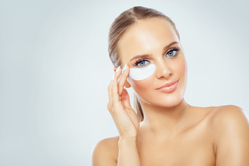 Woman face with mask under eyes, natural makeup