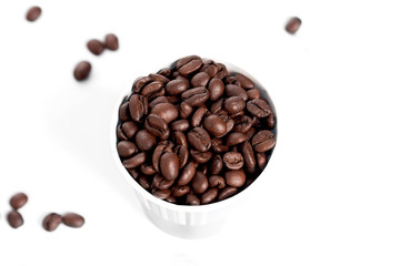 Grains of coffee on white background, close-up. View from above.