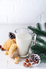 A stack of cookies and glass of milk for Santa on wooden background, concept Christmas and holiday