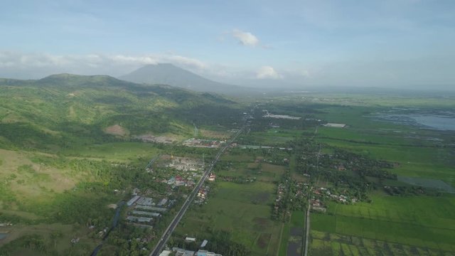 Aerial view of town in a mountain valley at the foot of the mountain Iriga. Luzon, Philippines. Mountainous tropical landscape.