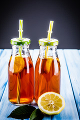 Lemons with lemonade on wooden table