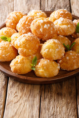 delicate chouquette dessert is decorated with pearl sugar and mint closeup. vertical