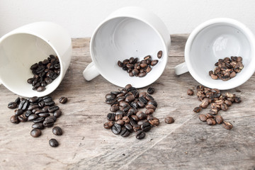 Roasted coffee beans of three different level in black bow on grunge wooden background,Coffee bean...