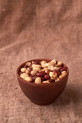 walnut peanut in clay bowl. peanuts for food textures. peanut harvest. fried peanuts. texture of the nuts. photo for layout. Copyspace