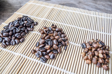 Roasted coffee beans of three different level in black bow on grunge wooden background,Coffee bean 3 level roast
