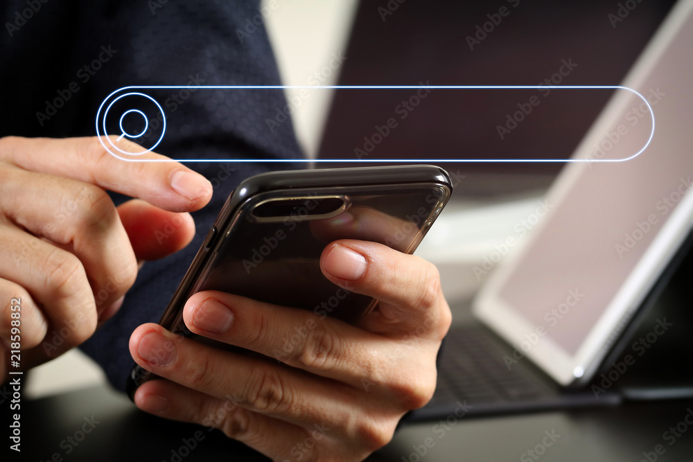 Poster close up of businessman hand working with smart phone and laptop and digital tablet computer in modern office