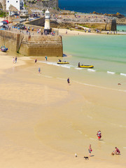 Families on the beach on a hot Summer day in St Ives, Cornwall.