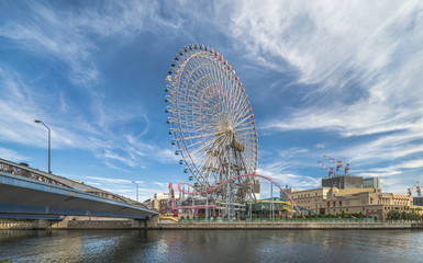 Big Wheel at Cosmo World Theme Park, overlooking the Diving Coaster Vanish in the Minato Mirai district of Yokohama with the Kokusai bridge on the left and the Anniversaire Cafe on the right.