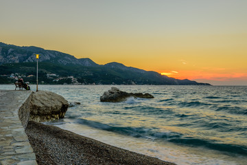 Beautiful sunset on the sea. The picturesque beach in Kokkari village, Samos island, Greece.