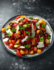 Healthy Red beans and mix of organic red and yellow pear shaped, beef heart and cherry tomatoes salad with picorino romano cheese shavings topped with parsley