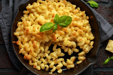Homemade baked macaroni and cheese with cheddar served on plate