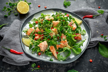 Fresh Salmon salad in asian style with sesame seeds, chili, lemon and green vegetables