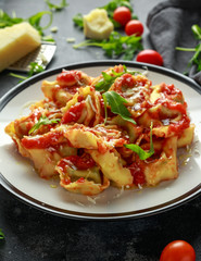 Spinach ricotta Ravioli in tomato sauce with wild rocket and parmesan cheese